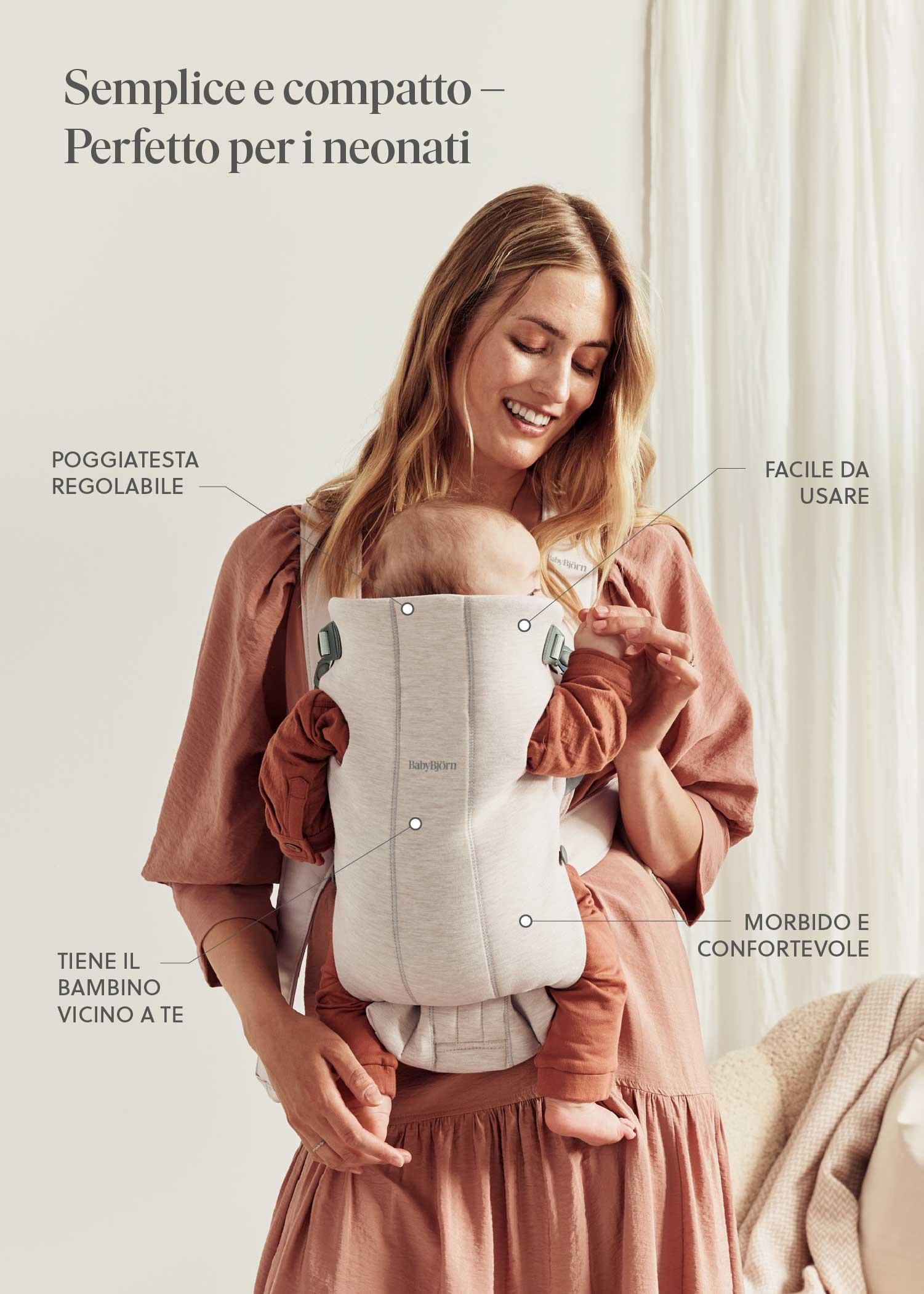 Woman smiling and wearing a baby carrier, holding a baby close. Italian text describing features like adjustable headrest and comfort. Light, airy room.